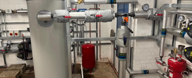 New immersion-feed hot water cylinder in the crematorium's main plant room with associated pump sets