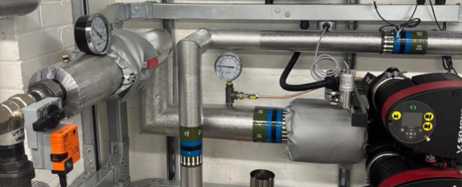 Grundfos primary circulation pumps and insulated pipework in the new heat pump plant room