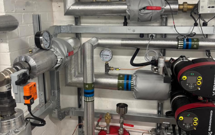 Grundfos primary circulation pumps and insulated pipework in the new heat pump plant room