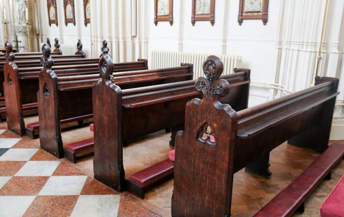 Rows of wooden pews inside a traditional English parish church